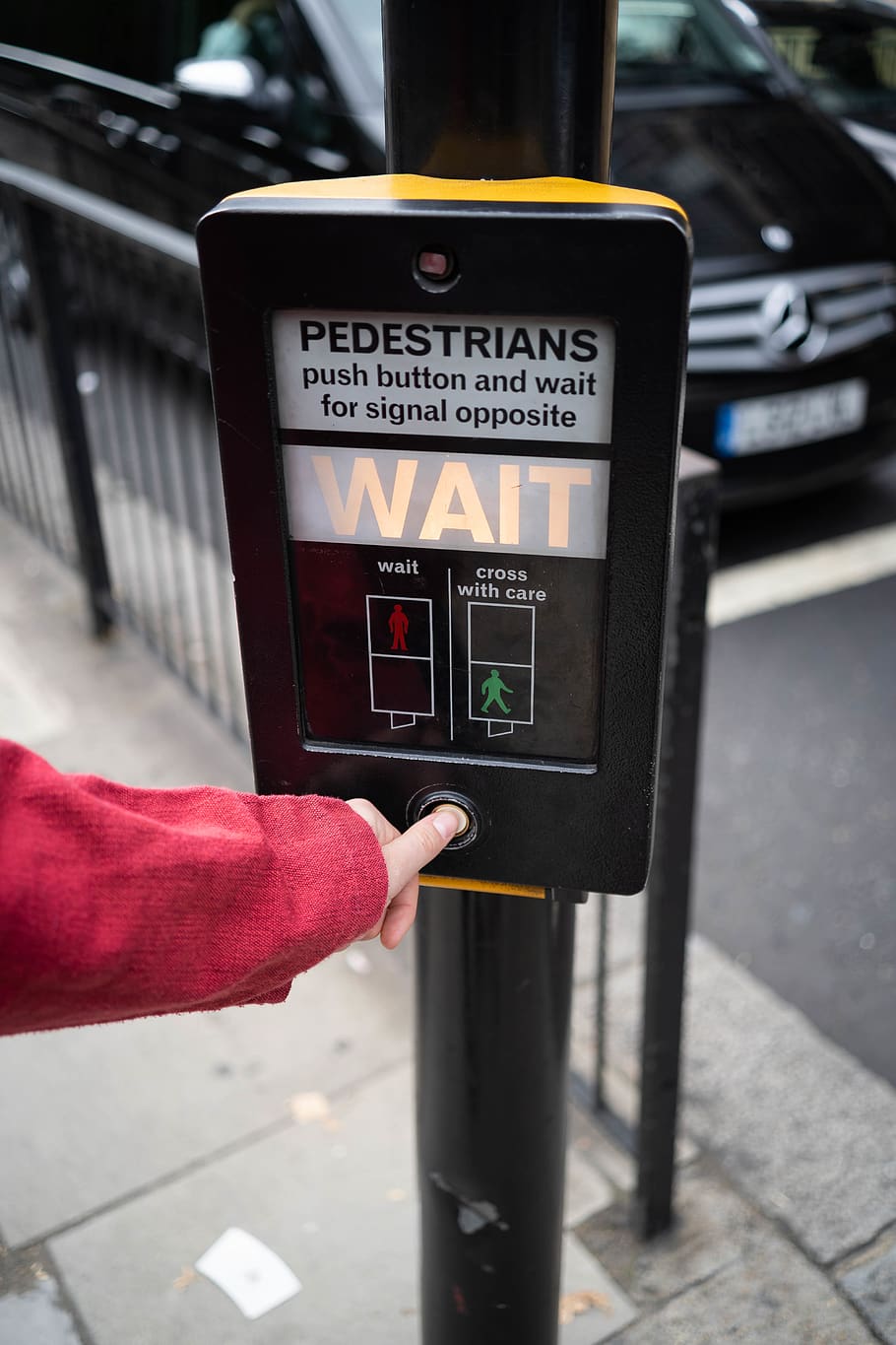 Photo of Person Pressing the Button of Pedestrian Box, blur, car