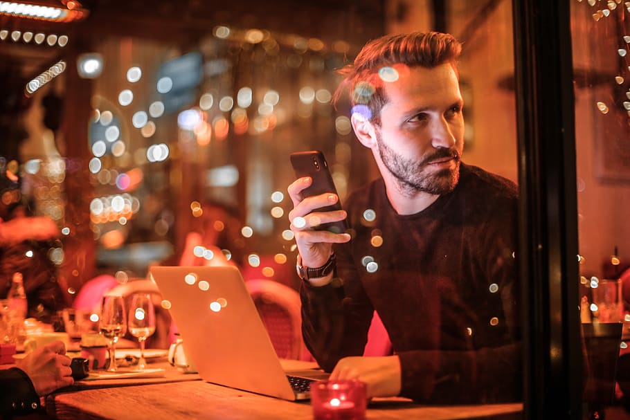 man holding smartphone beside table, human, person, people, hungary HD wallpaper