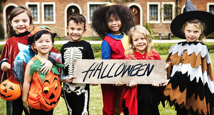 Photo of children in Halloween Costumes Smiling, board, boy, cheerful