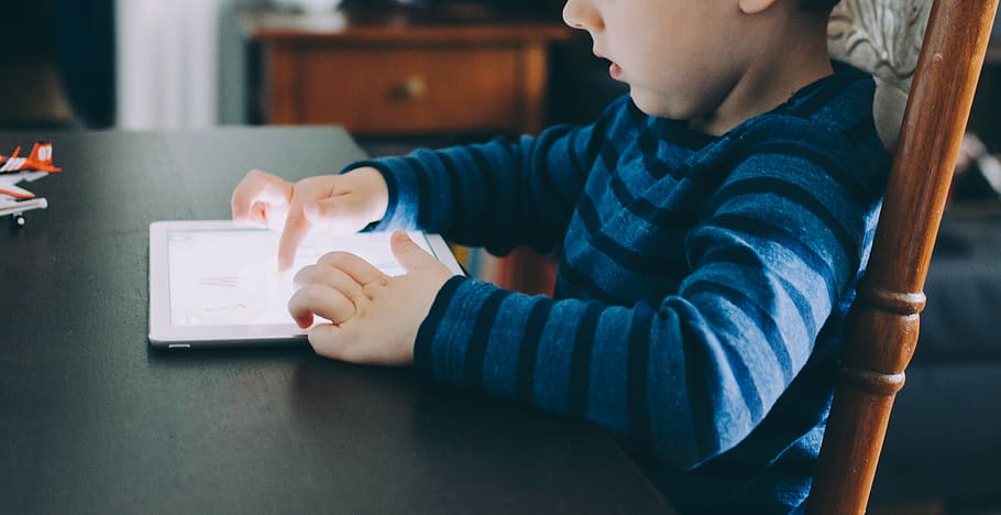 boy sitting on chair beside table using tablet computer, child HD wallpaper