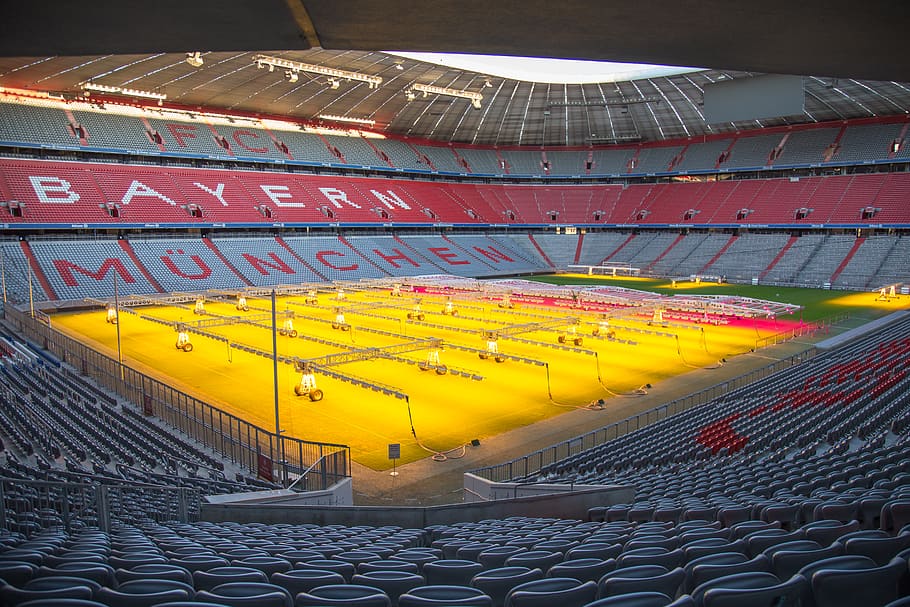 yellow, gray, and red Bayern Munchen stadium during daytime, building