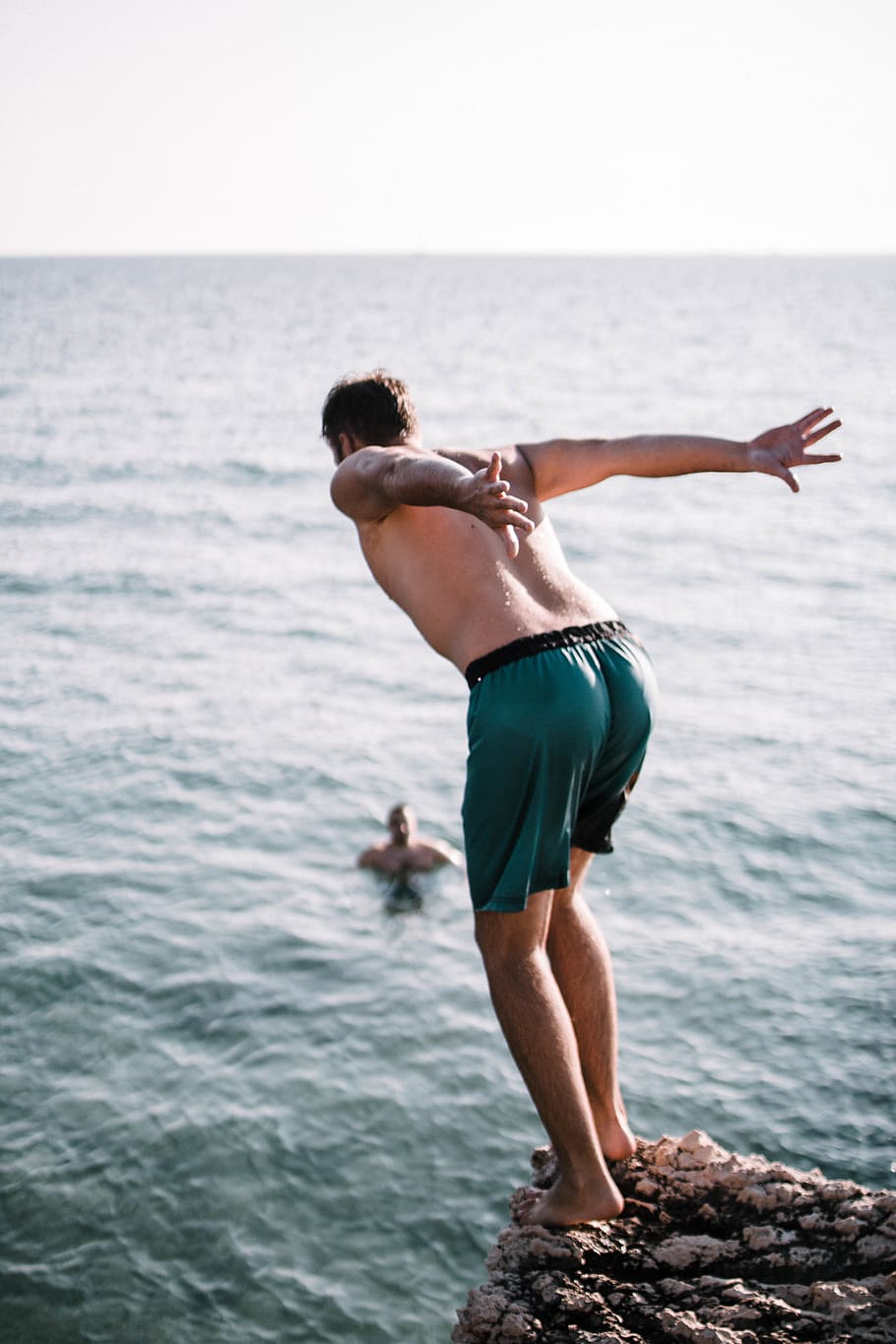 hd-wallpaper-man-on-cliff-about-to-jump-barefoot-beach-enjoyment