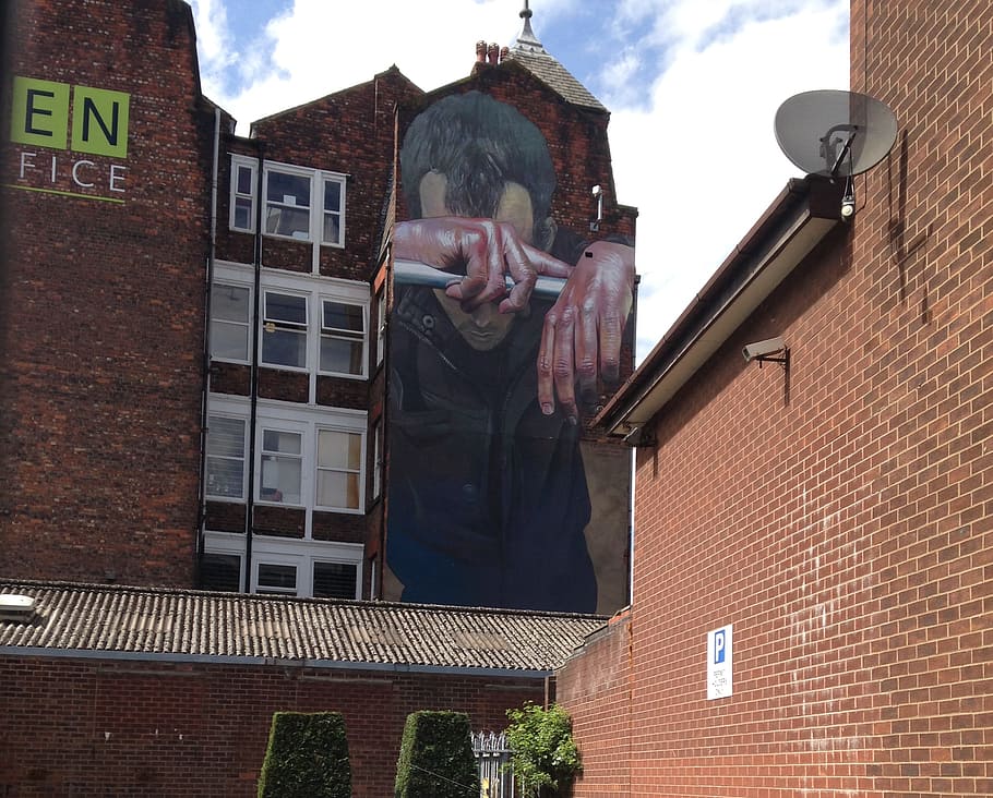 Giant mural on the side of an office conversion in New Cross, Manchester.