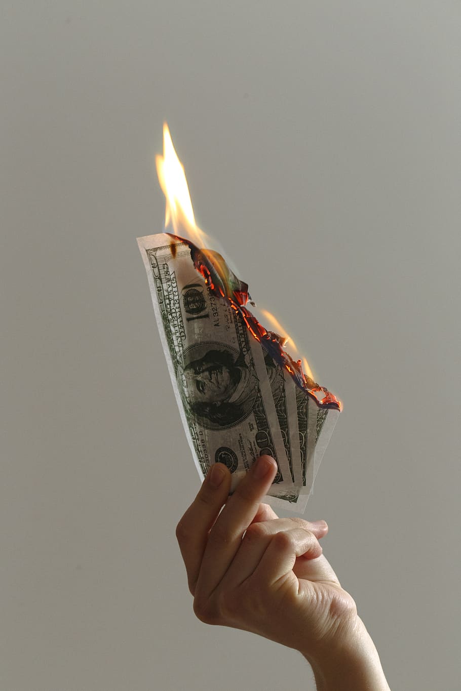 person holding lighted dollar bills, human, fire, money, candle
