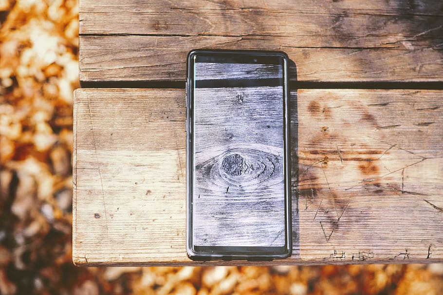 turned-on smartphone on picnic table, wood - material, technology HD wallpaper