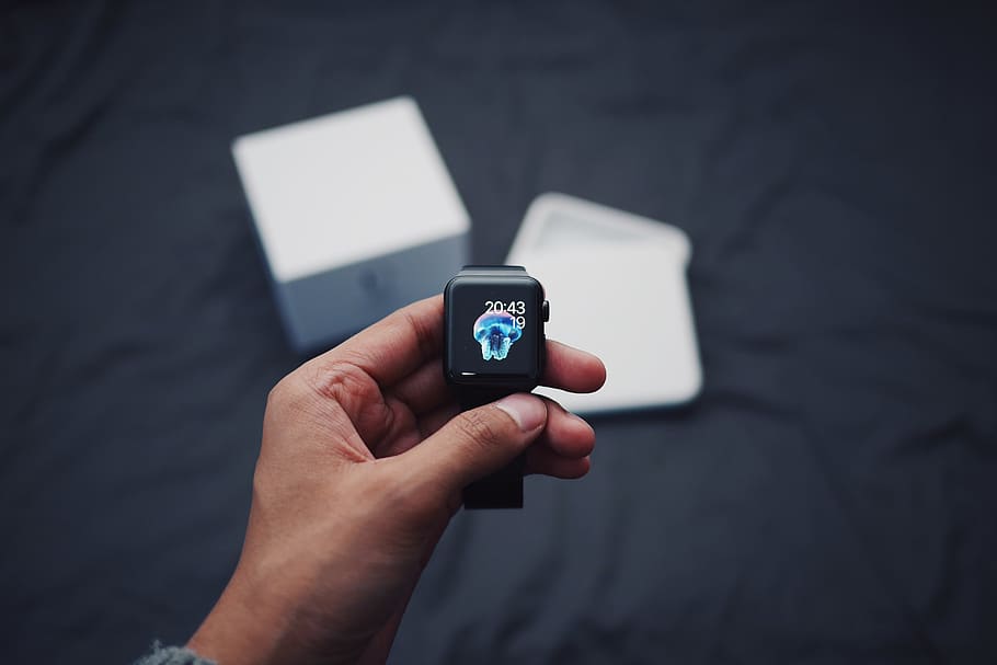 Person Holding Black Smartwatch, device, digital, hand, technology HD wallpaper