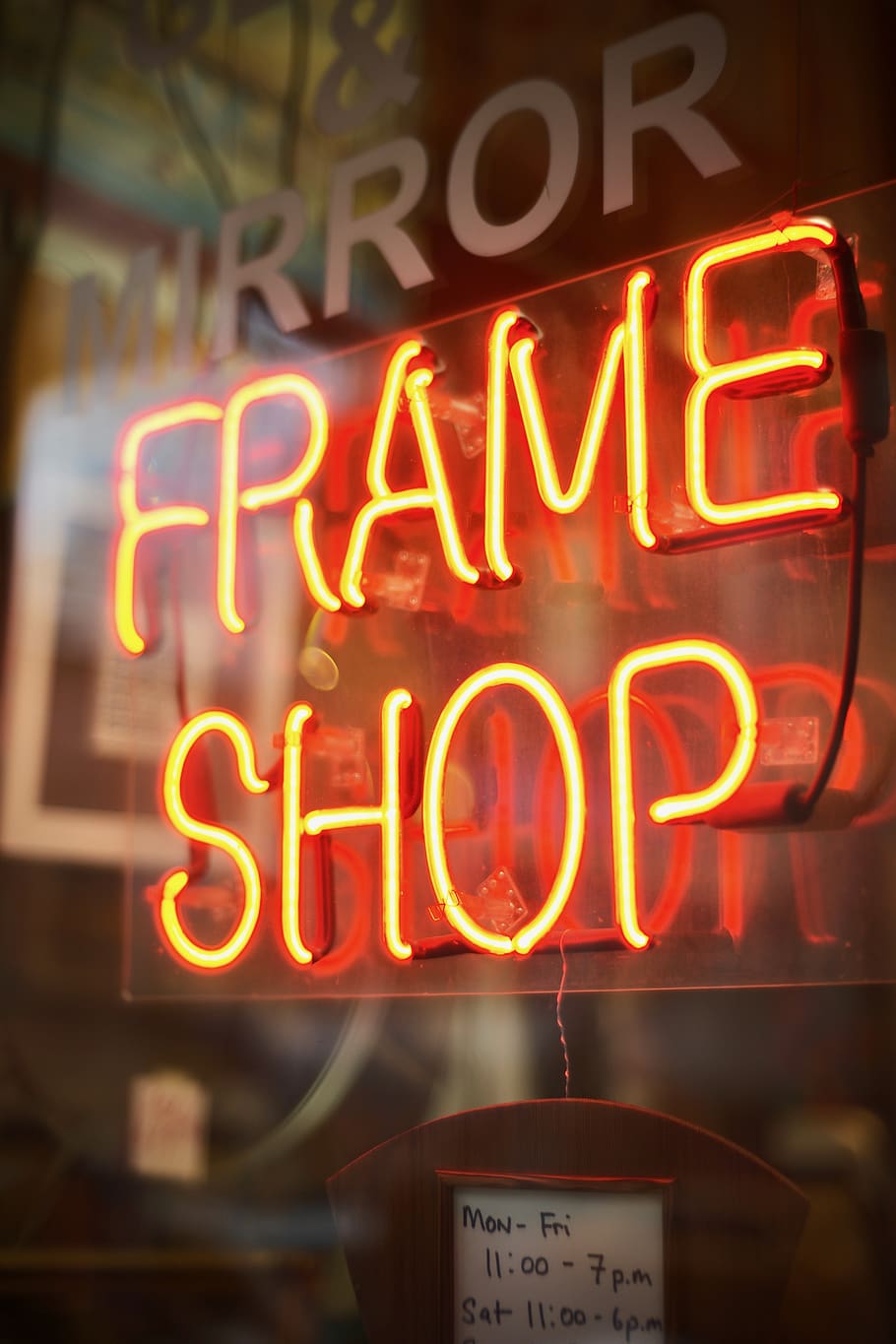 frame-shop-neon-signage-turned-on-window