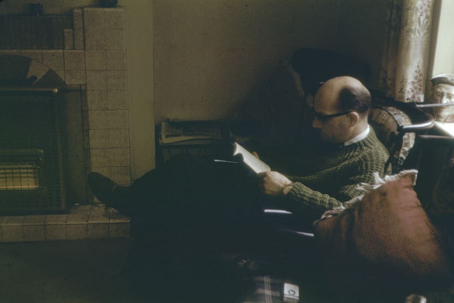 man sitting on sofa while reading book, human, person, 35mm, shot on film, HD wallpaper