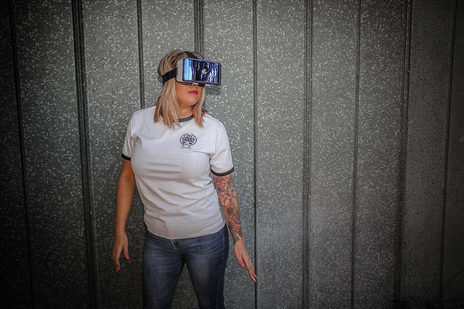 Photograph of Woman Wearing Vr Glass in Front of Wall, person