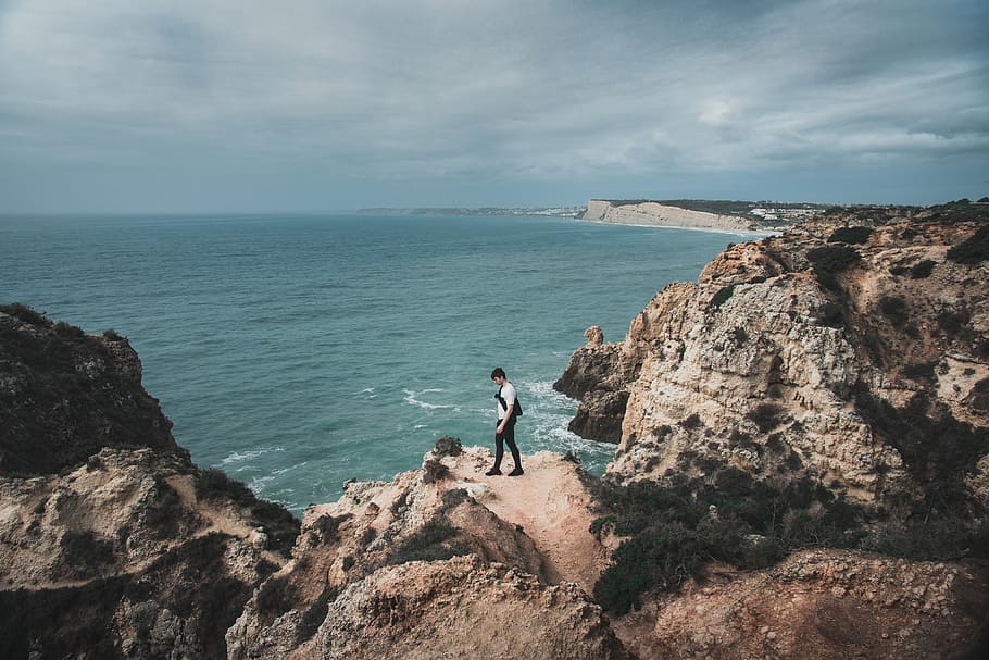 man on rocky mountain, outdoors, cliff, coast, portugal, ocean HD wallpaper