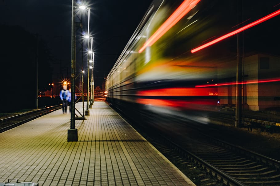 Man Walking on Train Rail, commuting, dark, evening, light streaks HD wallpaper