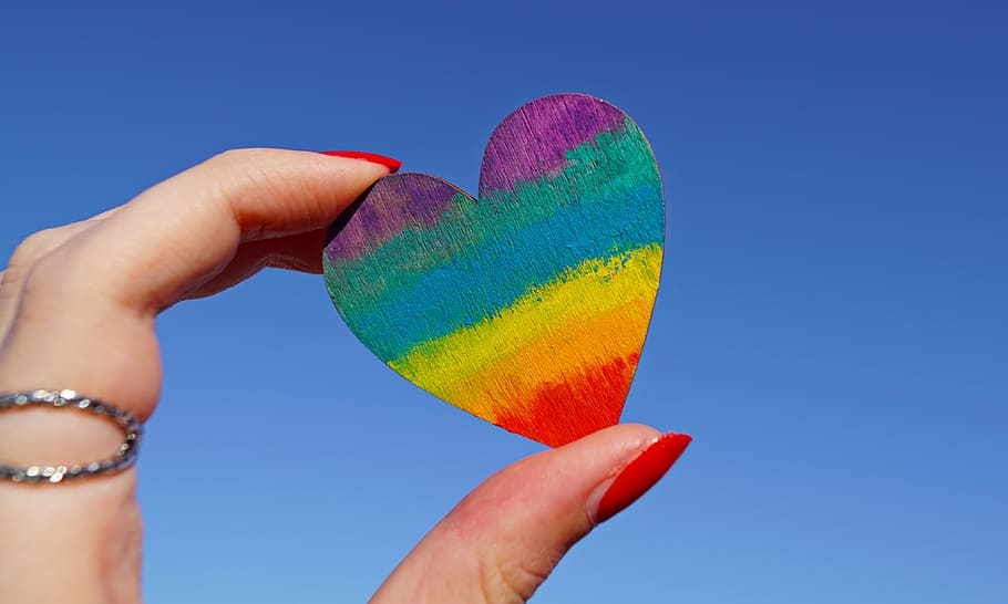 Person Holding Multicolored Heart Decor, 4k wallpaper, close-up