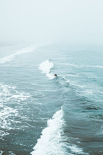 person surfing on wavy sea, ocean, wave, fog, misty, overcast HD wallpaper
