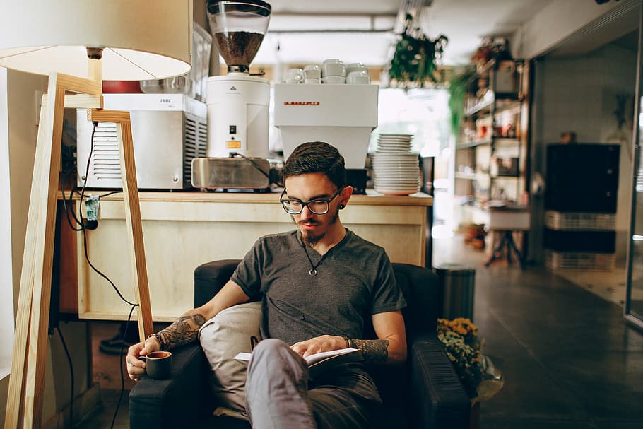 Man Sitting On Armchair White Reading Book, cup, drink, mug, person HD wallpaper