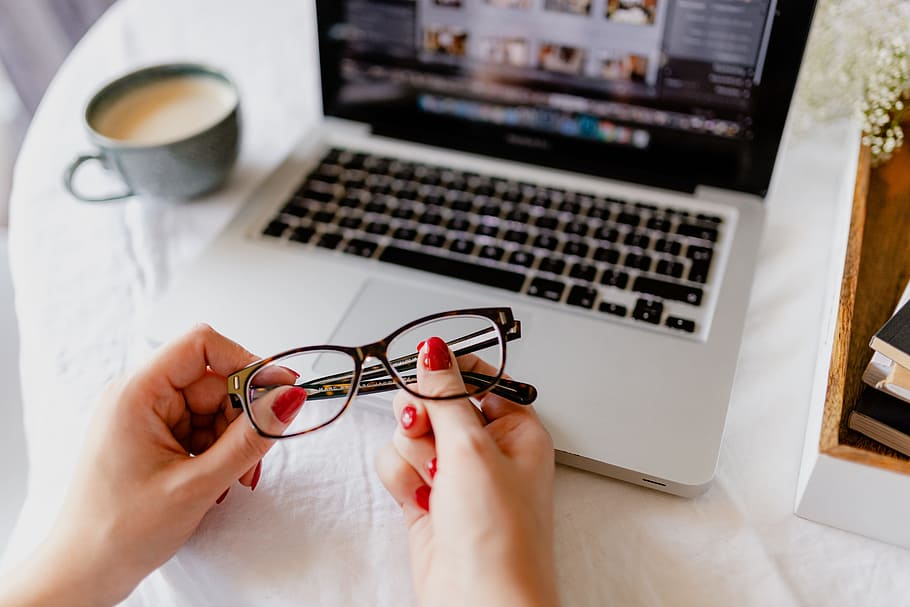 A woman works at a desk with a laptop and a cup of coffee, macbook HD wallpaper