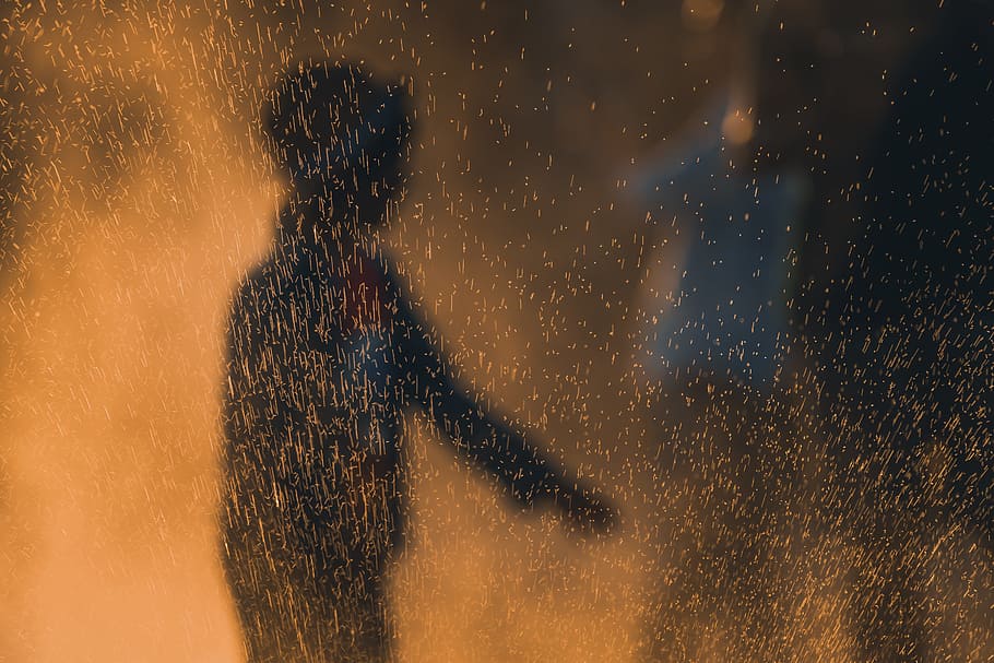 person, spark, mist, light, silhouette, dark, night, evening HD wallpaper
