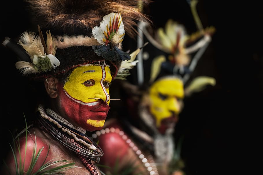 man with yellow and red face paints, people, tribe, bokeh, blur HD wallpaper