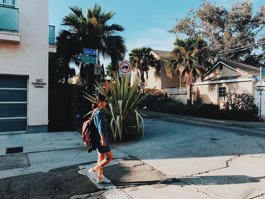 walking woman with backpack near house at daytime, human, person