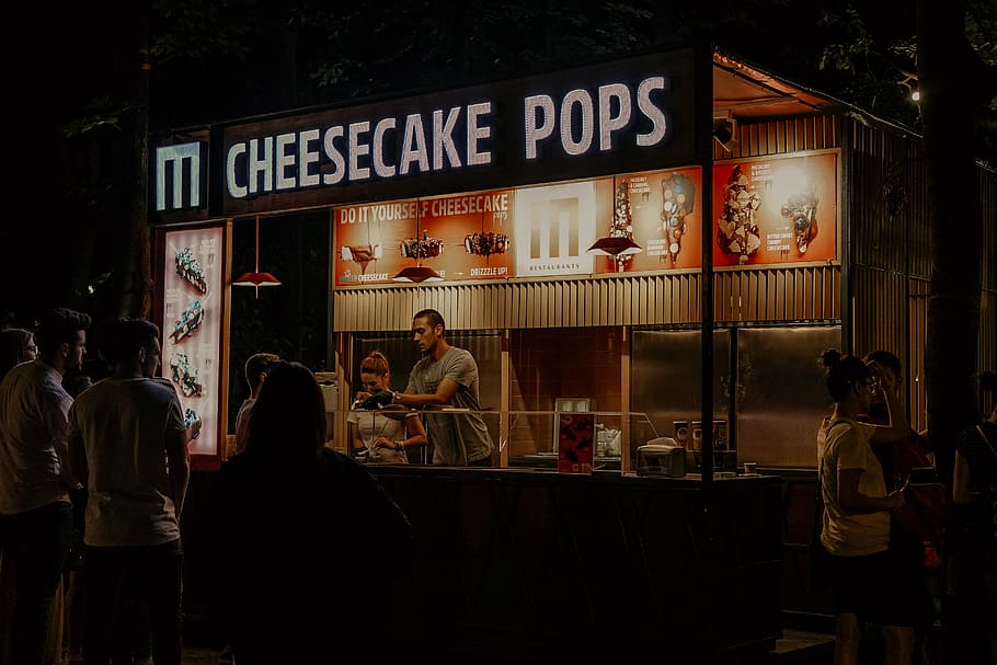 Cheesecake Pops food stall with people at night, person, human