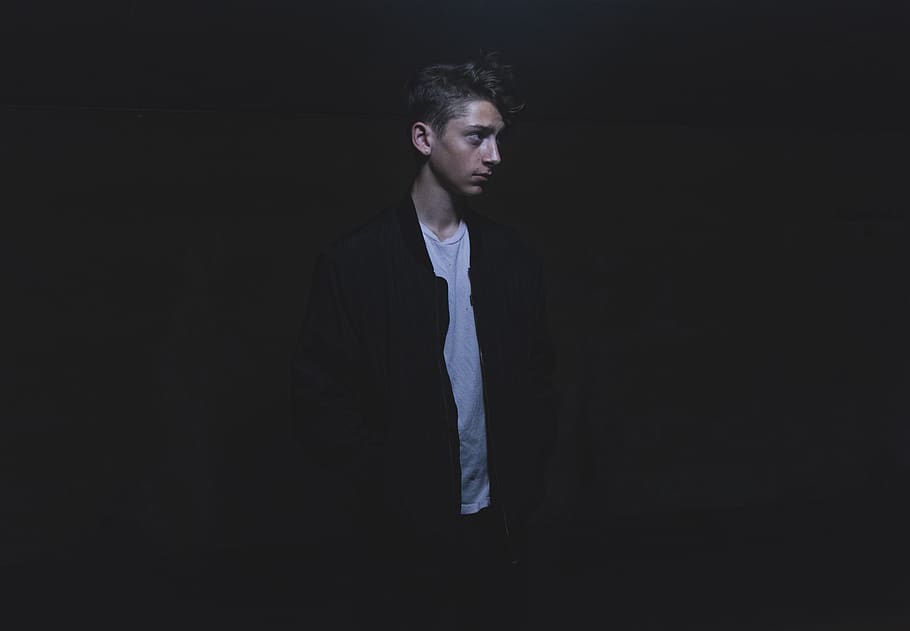 person wearing black jacket, studio shot, black background, one person HD wallpaper