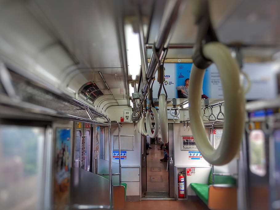 selective focus photography of train interior, human, person