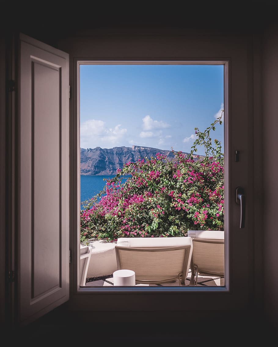 opened window showing outdoor lounger and pink flowers with mountain background HD wallpaper