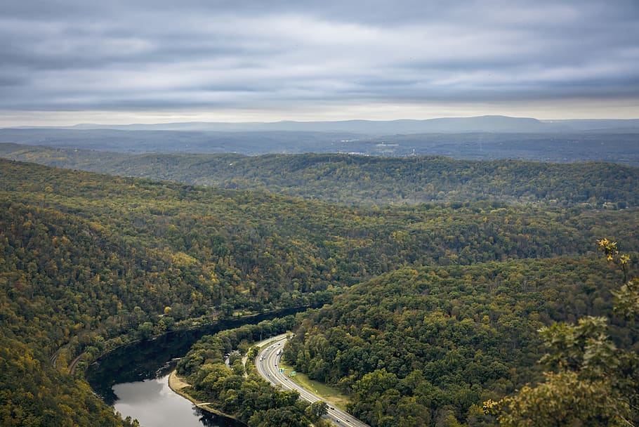 river surrounded by trees under dramatic clouds during daytime HD wallpaper
