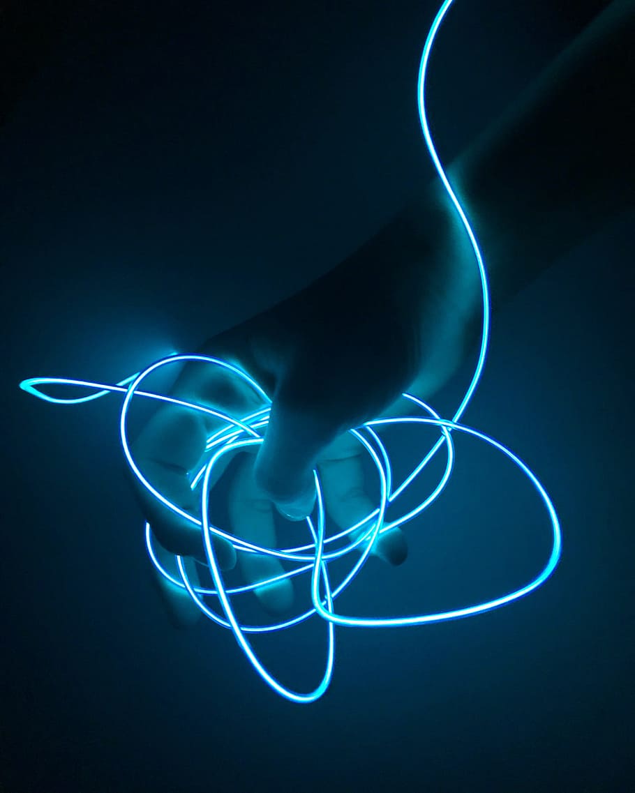 person holding blue lighted string, hand, neon, dark, night, evening