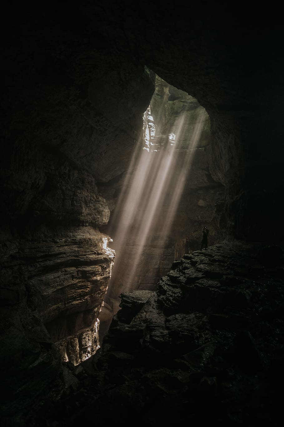 brown cave, ray, beam, light, hole, girl, person, taking photo