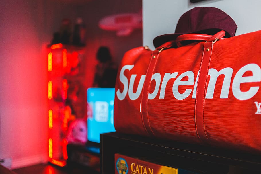 red Supreme leather duffel bag, human, person, drink, beverage