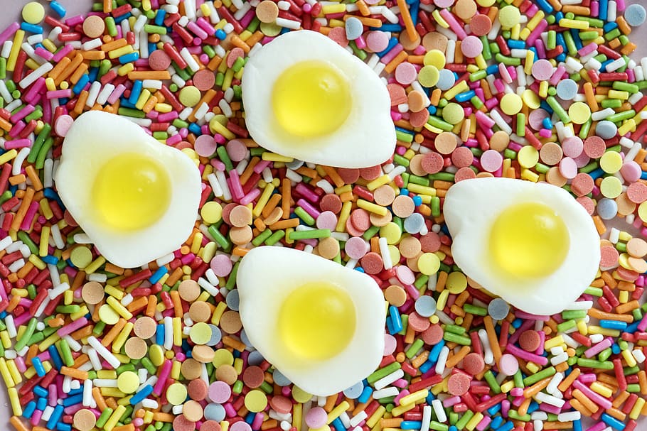 Four Sunny Side Up Egg Miniatures on Assorted-color Candies, background HD wallpaper