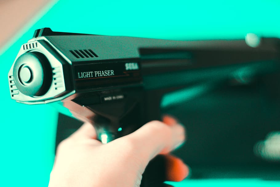 person holding black light phaser, human, gun, camera, electronics HD wallpaper