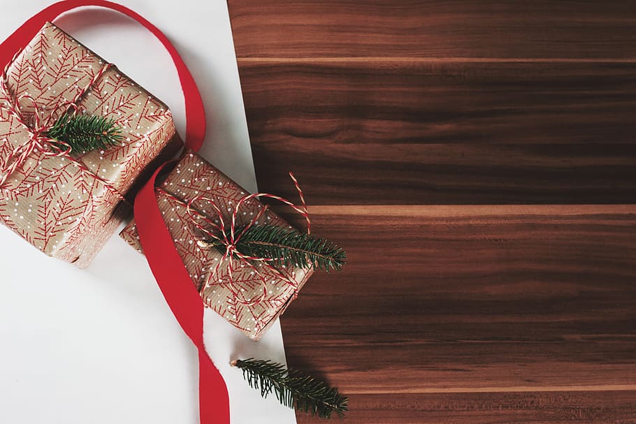 Christmas presents laid on a wooden table background, celebration HD wallpaper