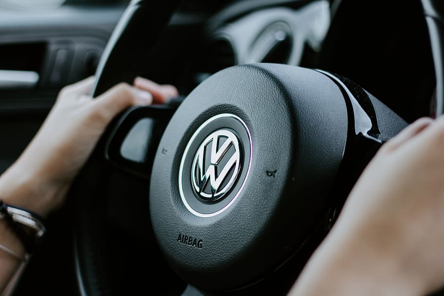 person holding black Volkswagen steering wheel in closed-up photo, HD wallpaper