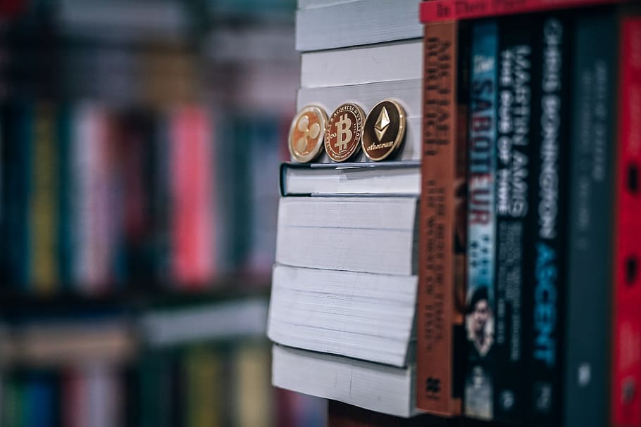 Beautifully Crafted Gold-Plated Cryptocurrency Coins Placed on Books, Illustration To Buy Books For School with Cryptocurrencies. HD wallpaper