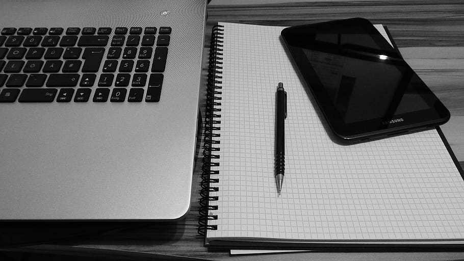 Smartphone Displaying Black Screen Beside Retractable Pen on Grid Notebook HD wallpaper