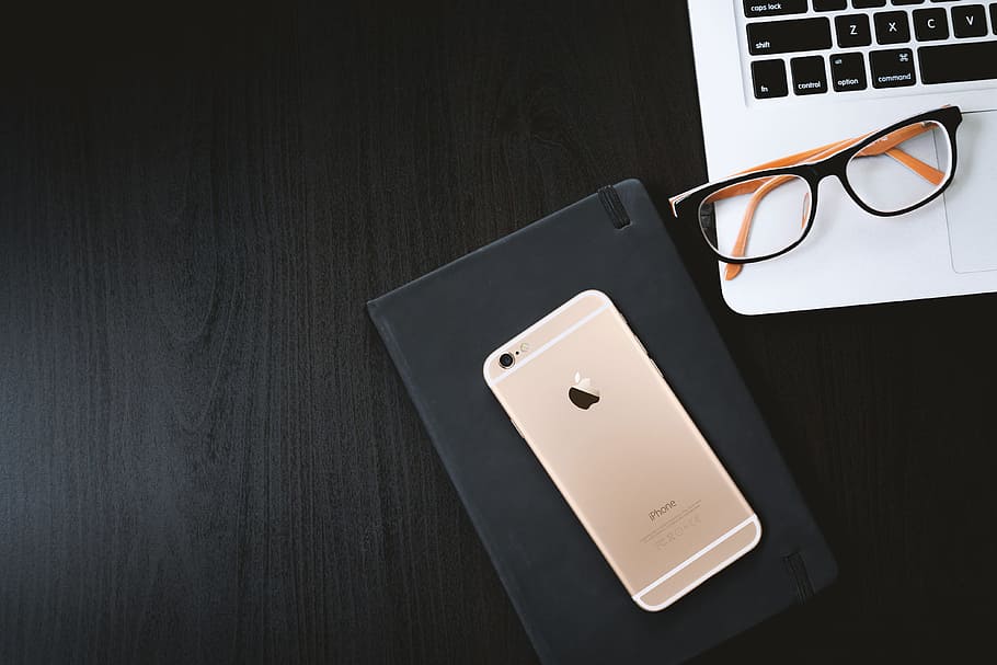 Working a black table with a laptop, smartphone and diary, glasses HD wallpaper