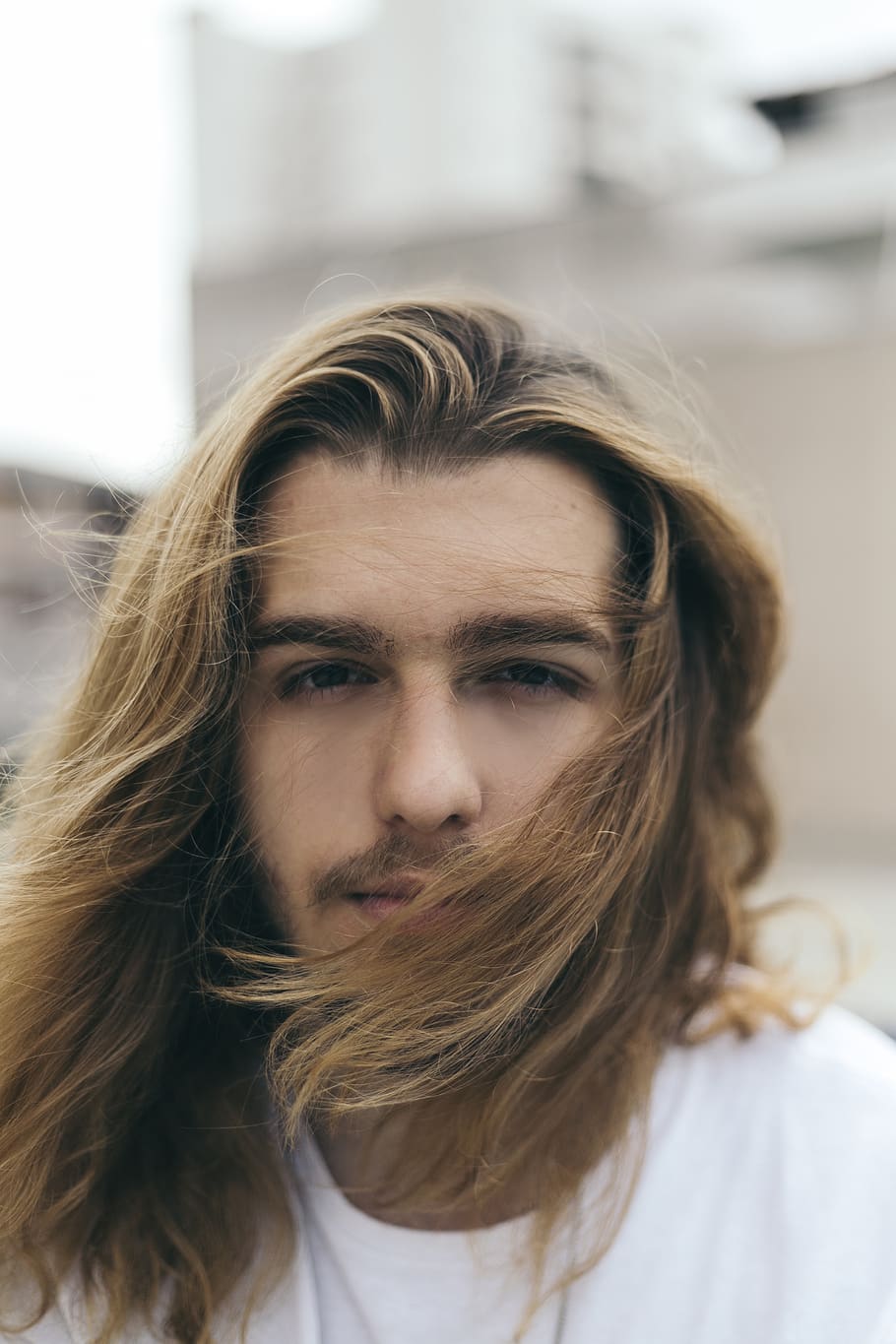 Selective Focus Photo of Long-haired Man, blond hair, blurred background