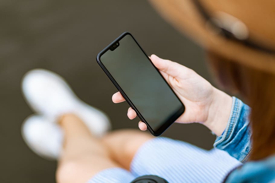 Person Holding Black Smartphone, blur, hand, looking, mobile phone HD wallpaper