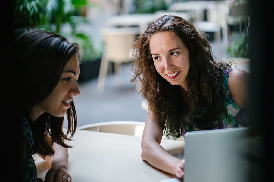 Two Talking Women While Using Laptop, chairs, daytime, discussing HD wallpaper