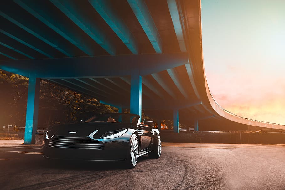 black Aston Martin convertible coupe parked beside blue concrete bridge, HD wallpaper