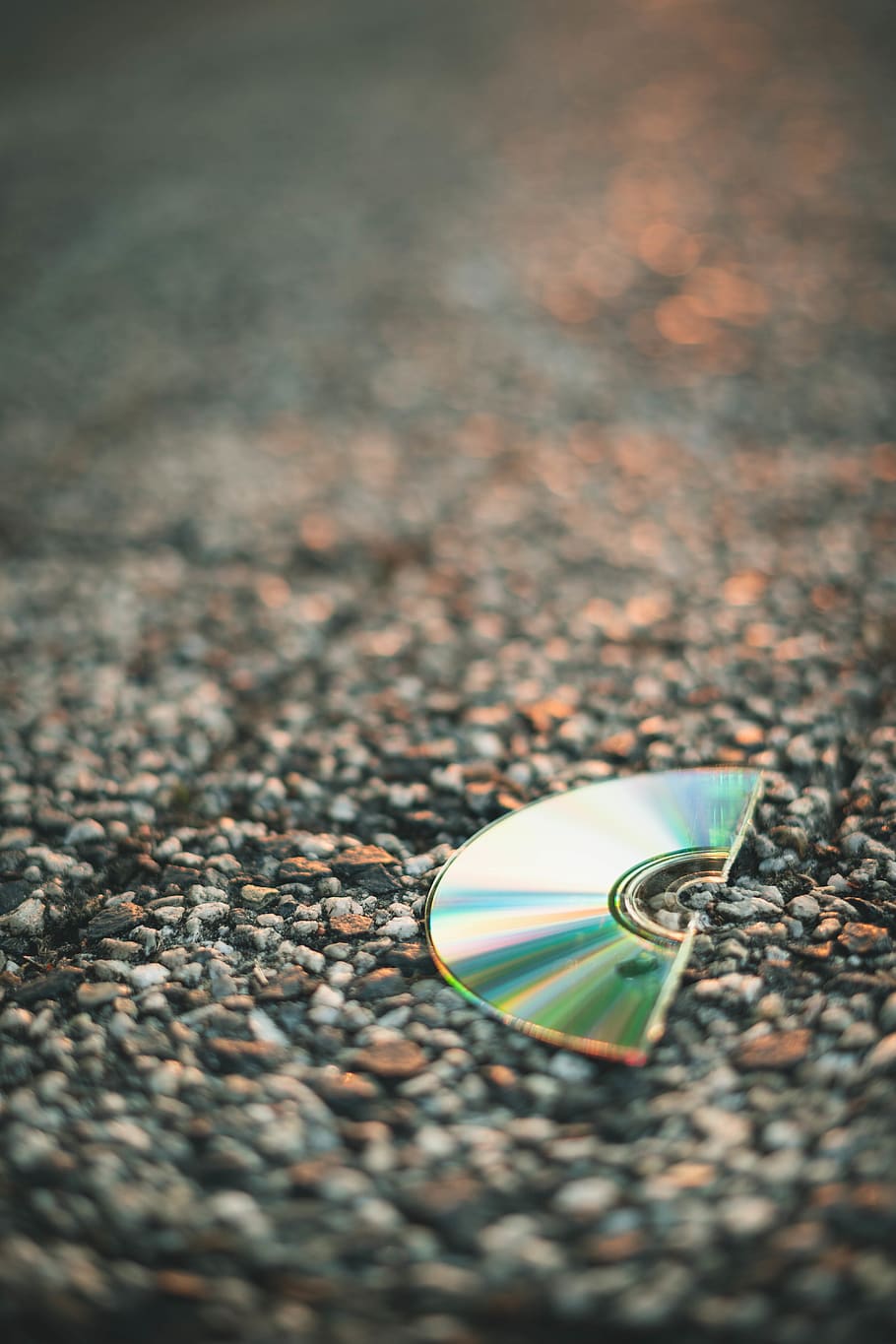 Selective Focus Photography of Half Cut Compact Disc on Gray Pavement HD wallpaper
