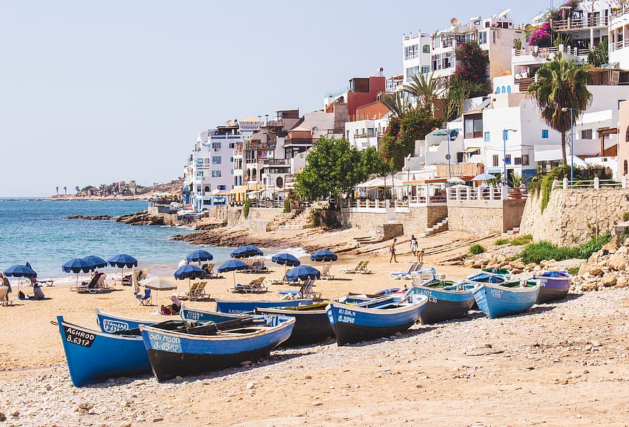 blue boats in beach near city, sea, coast, nature, ocean, outdoors, HD wallpaper