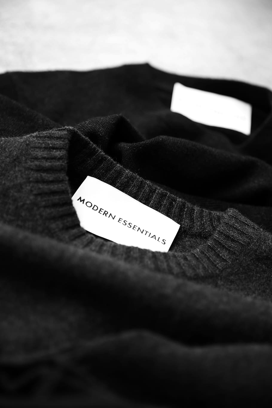 black Modern Essentials sweater, text, western script, selective focus HD wallpaper