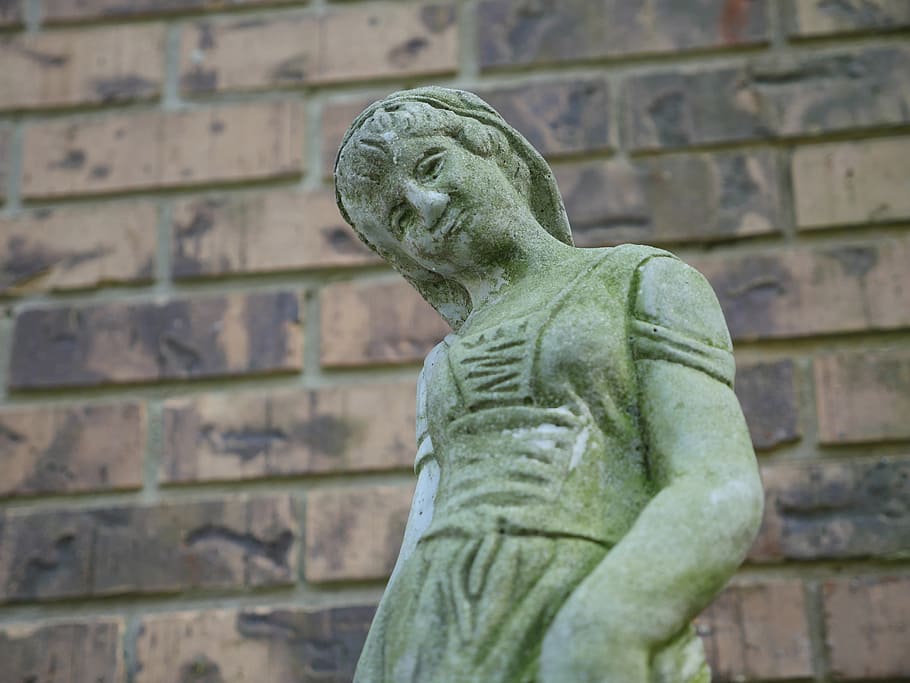 Stone statue of a woman in front of a wall of bricks, art, face HD wallpaper