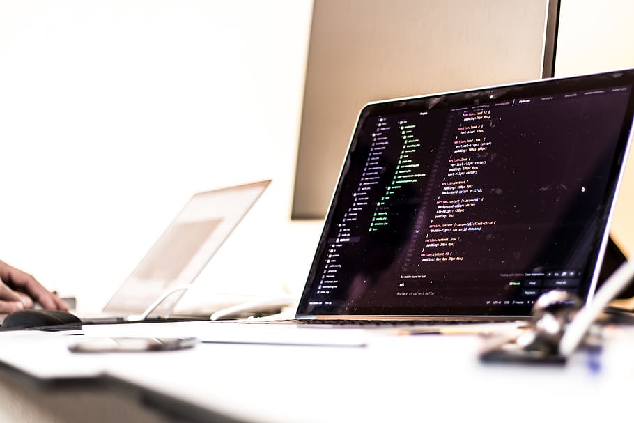 black laptop computer turned-on displaying source code on table HD wallpaper