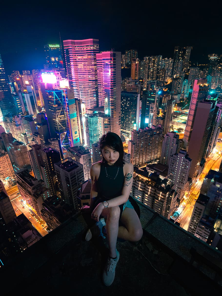 Photo of Woman Sitting On Rooftop, architecture, buildings, city