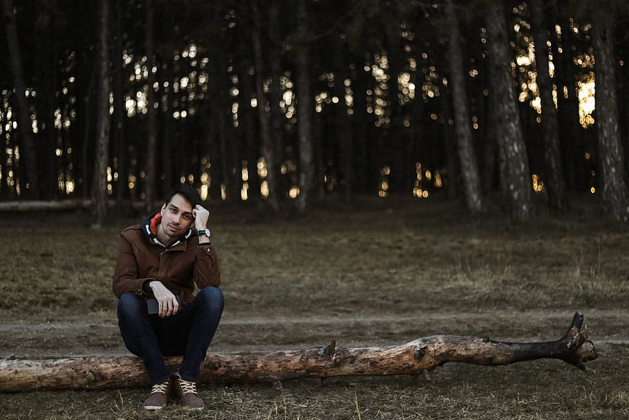 man sitting on tree trunk, wood, person, human, clothing, apparel HD wallpaper