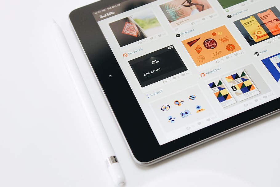 turned-on black iPad and white Apple Pencil, graphic designer