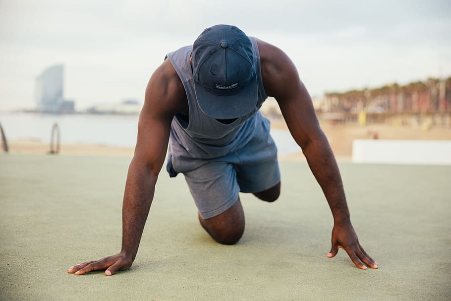 A young African man wearing causals stretching outdoors, 25-30 year old, HD wallpaper